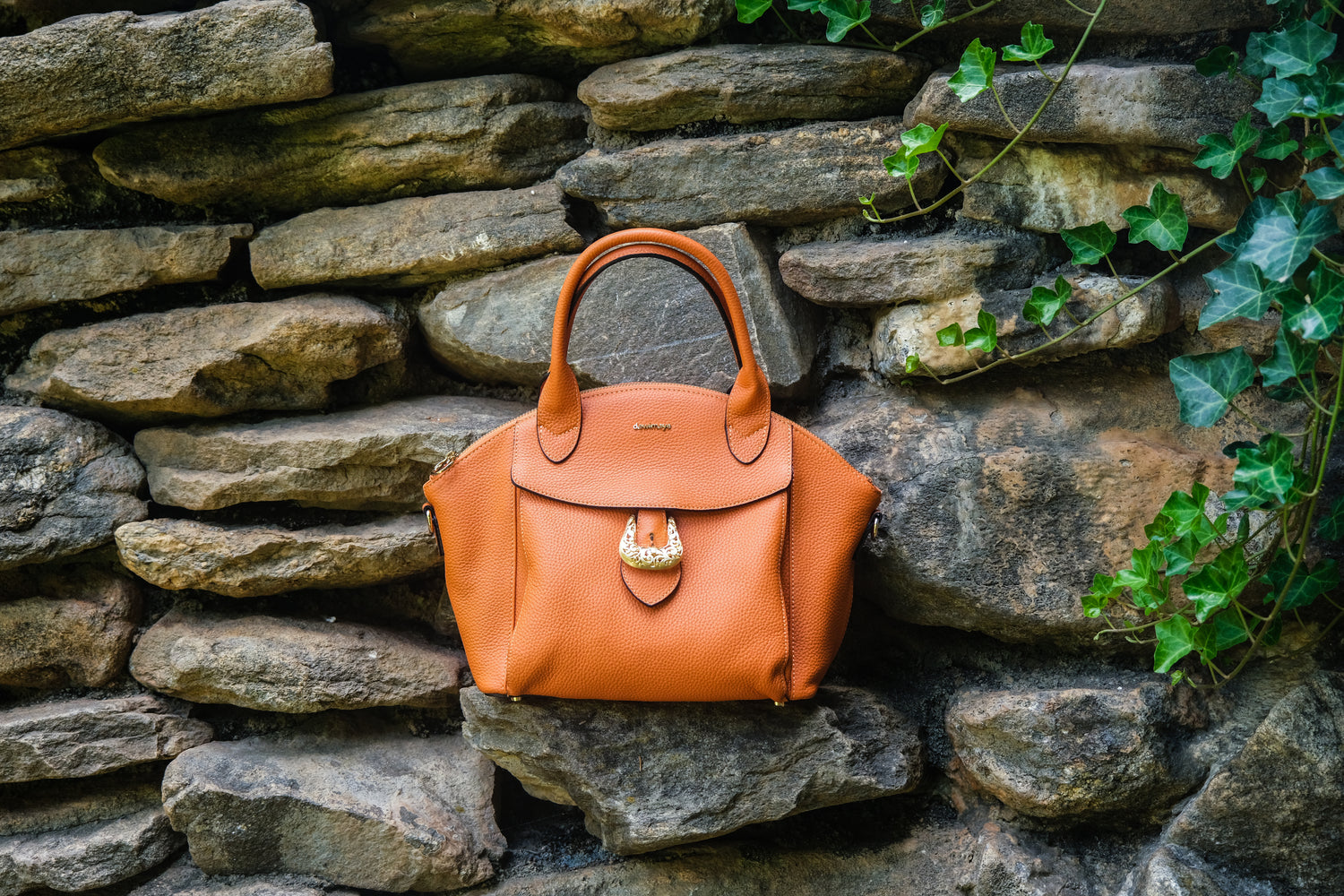 Bali Sunset Orange Pebble Grain Leather Handbag front view made by Dewi Maya available at the best boutique in Upstate South Carolina Spartanburg Greenville Dewi Maya Boutique